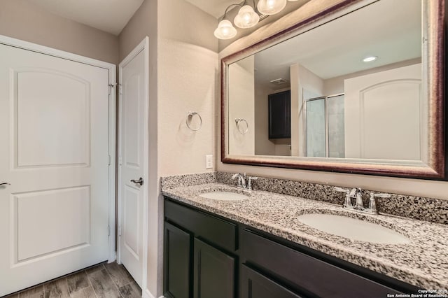 3354 Blossom Row, San Antonio, TX 78253 - bathroom with double vanity, wood finished floors, and a shower with door