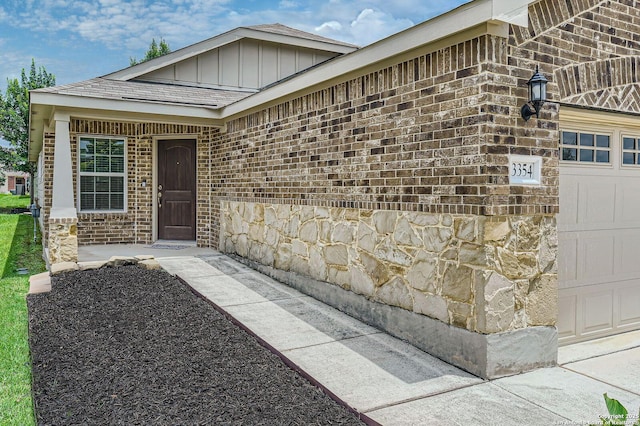 3354 Blossom Row, San Antonio, TX 78253 - property entrance with stone siding, a garage, board and batten siding, and brick siding