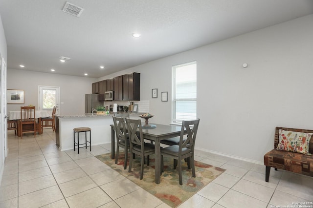 7883 Abbey, San Antonio, TX 78218 - dining area with plenty of natural light, light tile patterned floors, and recessed lighting