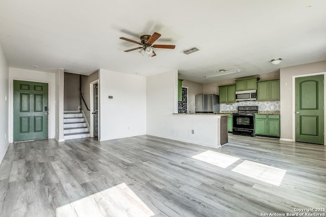 2907 Emery, San Antonio, TX 78222 - unfurnished living room featuring light wood-style floors, a ceiling fan, and stairs
