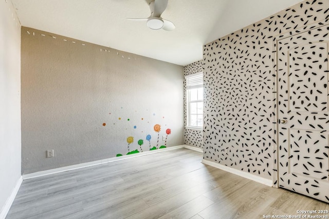 2907 Emery, San Antonio, TX 78222 - unfurnished room with wood finished floors, lofted ceiling, ceiling fan, and wallpapered walls
