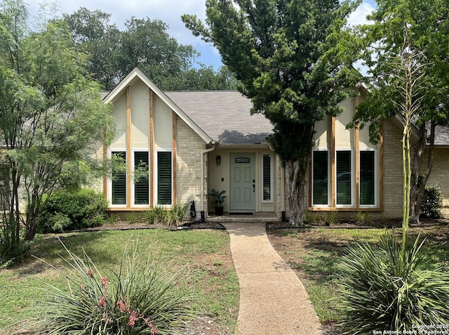 15115 Mission Oaks St, San Antonio, TX 78232 - view of front of home featuring stucco siding, brick siding, a front lawn, and a shingled roof