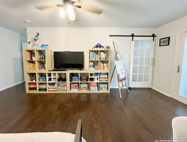 15115 Mission Oaks St, San Antonio, TX 78232 - living area featuring wood finished floors, a ceiling fan, and a barn door