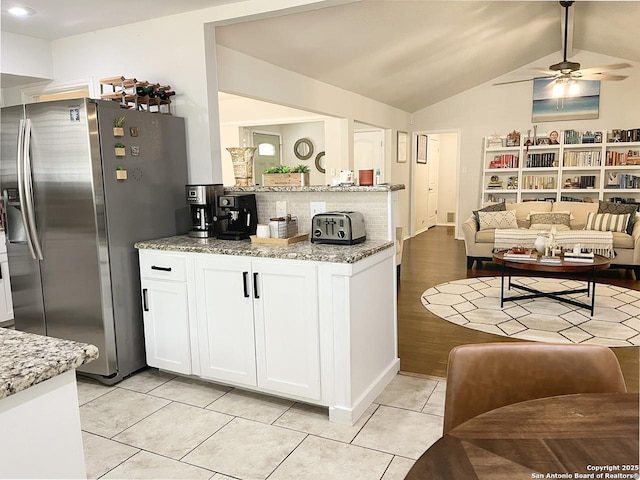 15115 Mission Oaks St, San Antonio, TX 78232 - kitchen with stainless steel fridge, open floor plan, backsplash, white cabinetry, and ceiling fan