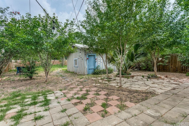 521 Kayton, San Antonio, TX 78210 - fenced yard featuring an outdoor structure and a patio area