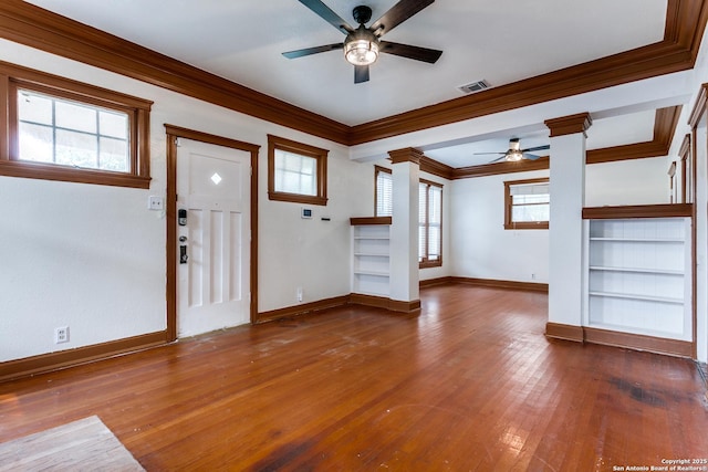521 Kayton, San Antonio, TX 78210 - unfurnished living room featuring a ceiling fan, ornamental molding, ornate columns, hardwood / wood-style flooring, and built in features