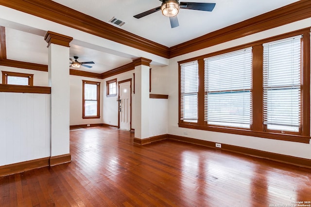 521 Kayton, San Antonio, TX 78210 - spare room with ceiling fan, ornamental molding, decorative columns, and dark wood-style flooring