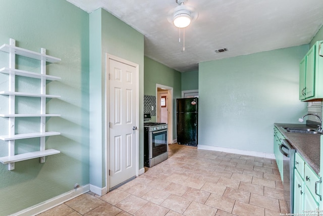 521 Kayton, San Antonio, TX 78210 - kitchen with stainless steel appliances, dark countertops, and a ceiling fan