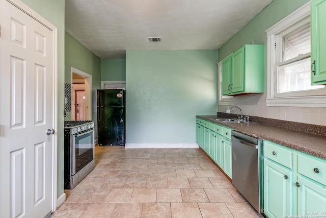 521 Kayton, San Antonio, TX 78210 - kitchen featuring appliances with stainless steel finishes, dark countertops, backsplash, and green cabinets
