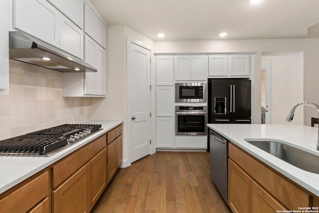 1845 Nettletree, New Braunfels, TX 78132 - kitchen with stainless steel appliances, exhaust hood, dark wood-type flooring, light countertops, and tasteful backsplash