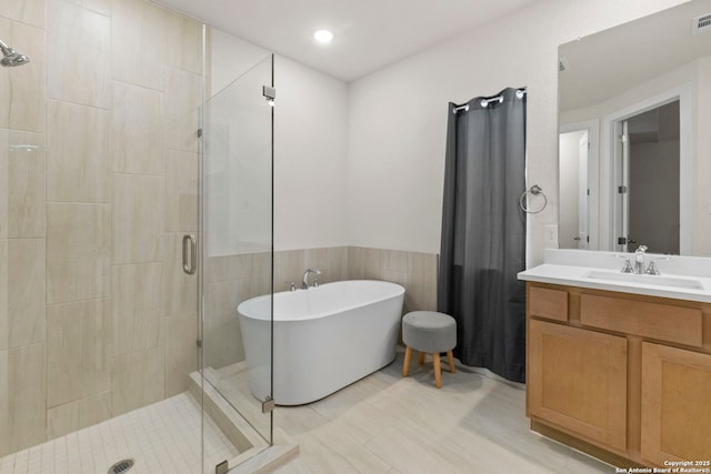 1845 Nettletree, New Braunfels, TX 78132 - bathroom with a stall shower, a freestanding bath, vanity, and wainscoting