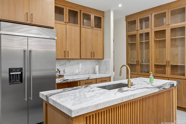 6 Turin Ct, San Antonio, TX 78257 - kitchen featuring built in fridge, light stone counters, tasteful backsplash, glass insert cabinets, and recessed lighting