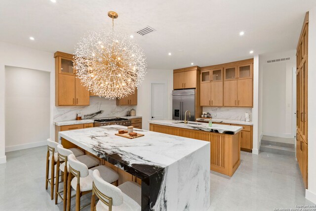 6 Turin Ct, San Antonio, TX 78257 - kitchen featuring a center island with sink, built in refrigerator, a chandelier, tasteful backsplash, and recessed lighting