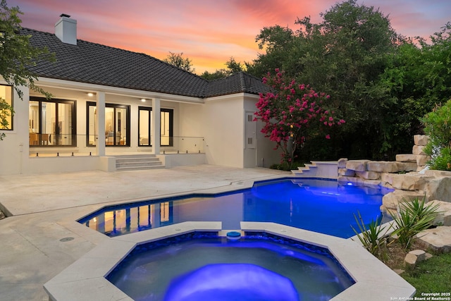6 Turin Ct, San Antonio, TX 78257 - pool at dusk with an in-ground hot tub, a patio, an outdoor pool, and french doors