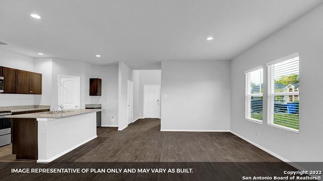 21039 Watercourse Way, San Antonio, TX 78266 - kitchen featuring stainless steel electric range oven, recessed lighting, dark wood-style flooring, dark brown cabinets, and an island with sink