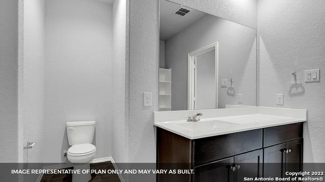 21039 Watercourse Way, San Antonio, TX 78266 - bathroom with a textured wall and vanity