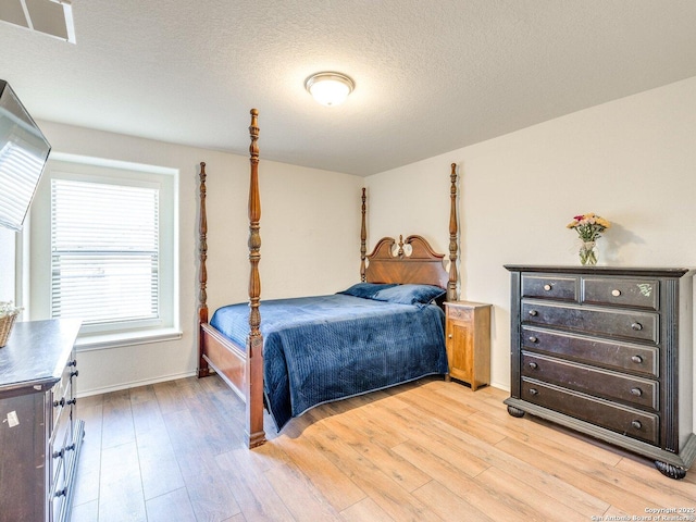 20127 Silver Strm, San Antonio, TX 78259 - bedroom with light wood-style floors and a textured ceiling