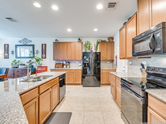 20127 Silver Strm, San Antonio, TX 78259 - kitchen with black appliances, recessed lighting, backsplash, light stone countertops, and light tile patterned floors