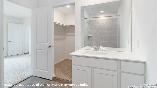 22926 Double Bogey, San Antonio, TX 78261 - full bathroom featuring vanity, a shower, recessed lighting, a spacious closet, and wood finished floors