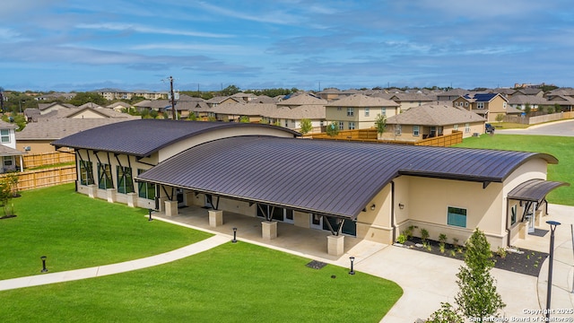 22926 Double Bogey, San Antonio, TX 78261 - back of property with a residential view, a standing seam roof, a metal roof, stucco siding, and concrete driveway