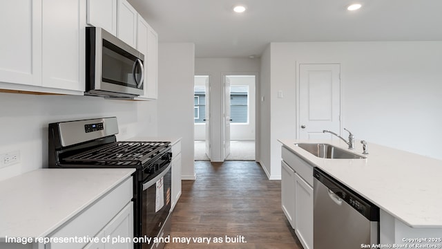 22926 Double Bogey, San Antonio, TX 78261 - kitchen with stainless steel appliances, dark wood-type flooring, white cabinets, recessed lighting, and a kitchen island with sink
