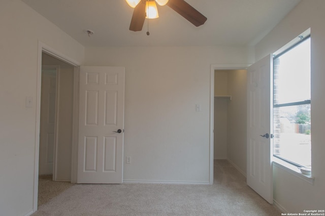 4602 Manitou Bay, San Antonio, TX 78259 - unfurnished bedroom featuring a walk in closet, multiple windows, light carpet, and a closet