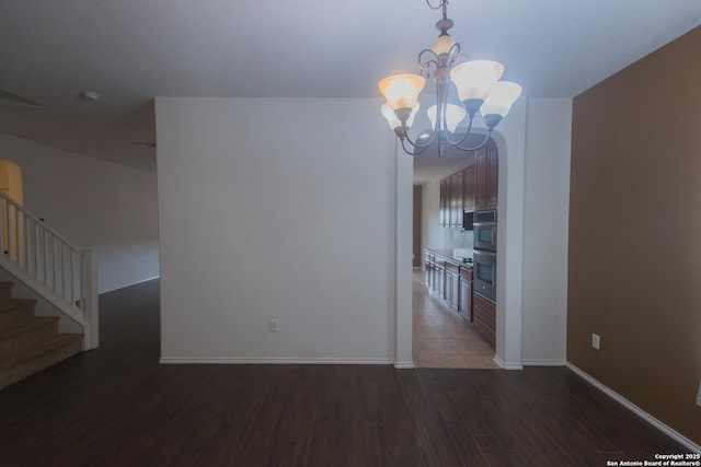 4602 Manitou Bay, San Antonio, TX 78259 - unfurnished dining area featuring wood finished floors, a chandelier, and stairway