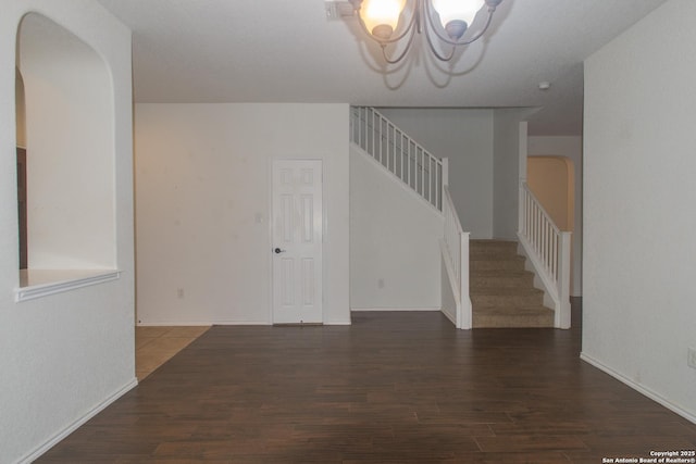 4602 Manitou Bay, San Antonio, TX 78259 - empty room featuring stairway, a chandelier, wood finished floors, and arched walkways