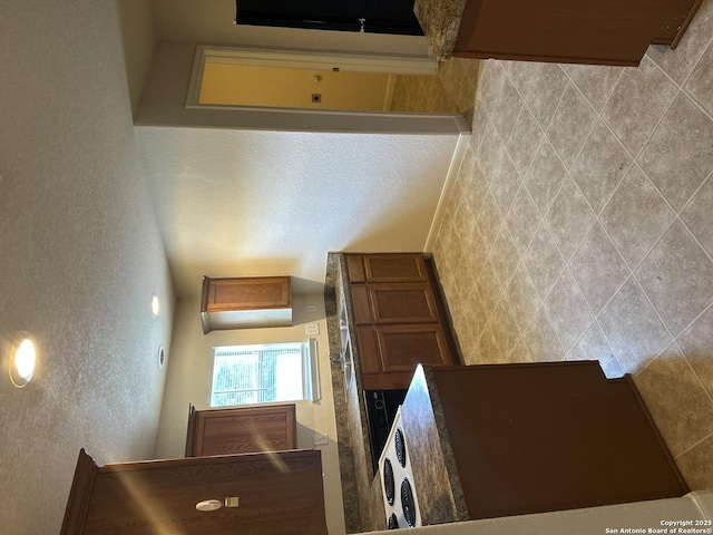 4606 Gambels Quail, Converse, TX 78109 - kitchen featuring a textured wall and brown cabinetry