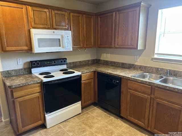4606 Gambels Quail, Converse, TX 78109 - kitchen with white microwave, dishwasher, range with electric stovetop, dark countertops, and brown cabinets
