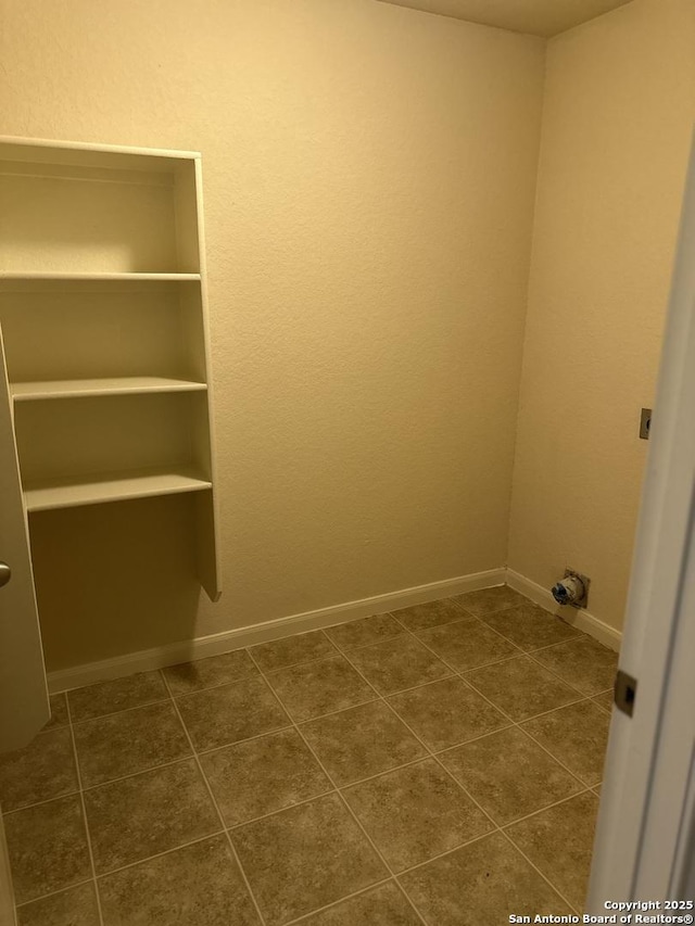 4606 Gambels Quail, Converse, TX 78109 - laundry room with dark tile patterned floors and baseboards