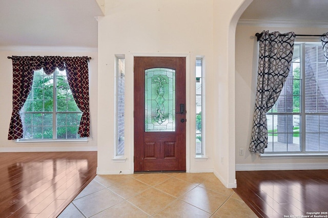 519 Catanbo, San Antonio, TX 78258 - entrance foyer with arched walkways, crown molding, and light tile patterned floors