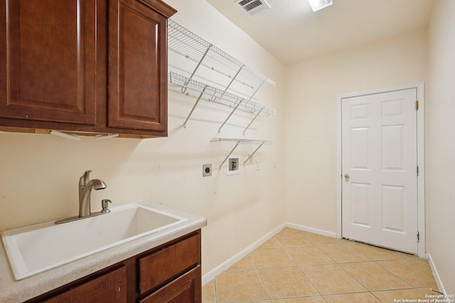 519 Catanbo, San Antonio, TX 78258 - laundry room with hookup for a washing machine, cabinet space, electric dryer hookup, and light tile patterned flooring