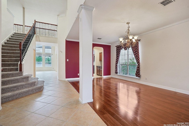519 Catanbo, San Antonio, TX 78258 - foyer featuring stairway, arched walkways, a chandelier, ornamental molding, and light tile patterned flooring