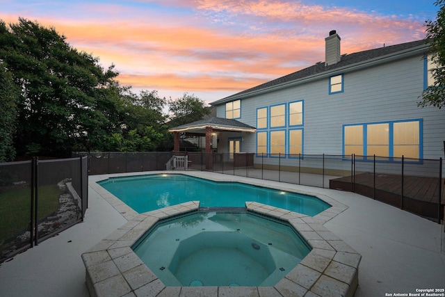 519 Catanbo, San Antonio, TX 78258 - pool at dusk with a pool with connected hot tub and a patio area