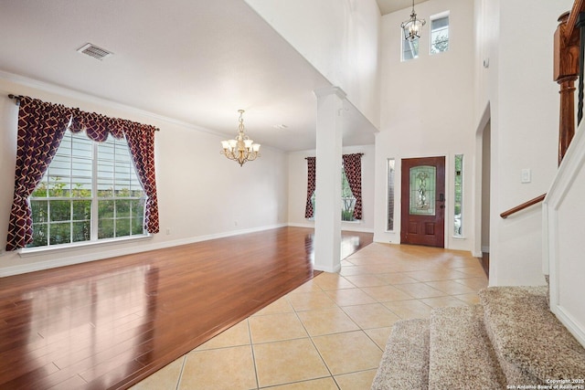 519 Catanbo, San Antonio, TX 78258 - foyer entrance featuring a chandelier, light tile patterned floors, stairs, and crown molding