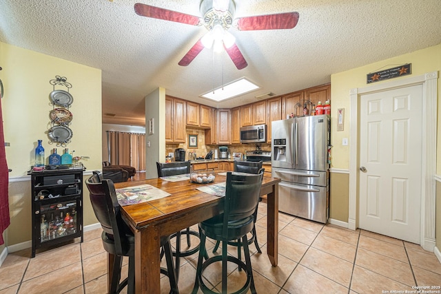 11002 Stagwood Pass, San Antonio, TX 78254 - kitchen with appliances with stainless steel finishes, ceiling fan, light tile patterned flooring, and a textured ceiling
