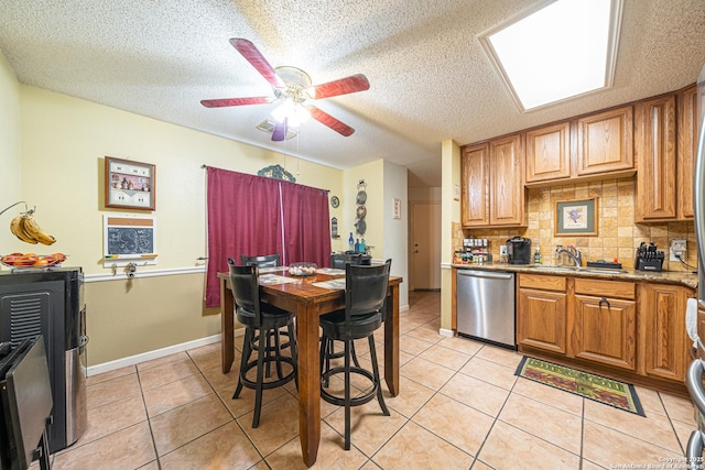 11002 Stagwood Pass, San Antonio, TX 78254 - kitchen featuring stainless steel dishwasher, a textured ceiling, light tile patterned flooring, tasteful backsplash, and ceiling fan