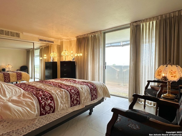 7039 San Pedro Ave Unit 601, San Antonio, TX 78216 - bedroom featuring access to exterior and a textured ceiling