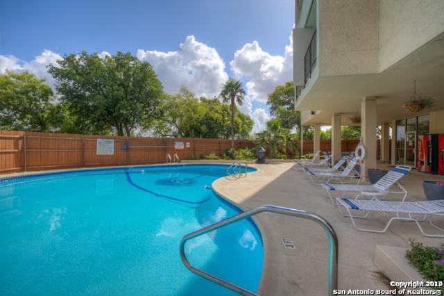 7039 San Pedro Ave Unit 601, San Antonio, TX 78216 - community pool featuring a fenced backyard and a patio