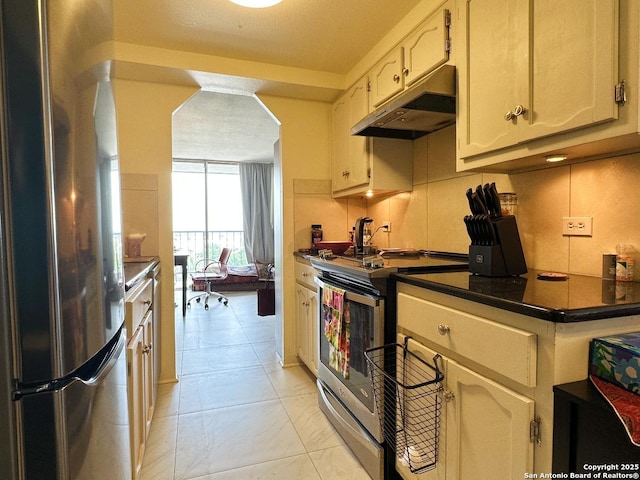 7039 San Pedro Ave Unit 601, San Antonio, TX 78216 - kitchen with appliances with stainless steel finishes, under cabinet range hood, dark countertops, and arched walkways