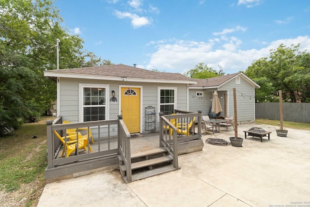 802 Poinsettia, San Antonio, TX 78202 - view of front of house with an outdoor fire pit, a patio, a wooden deck, and roof with shingles