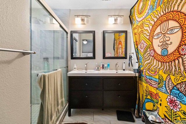 802 Poinsettia, San Antonio, TX 78202 - full bath with double vanity, a shower stall, and a textured wall