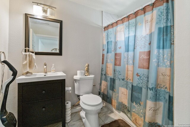 802 Poinsettia, San Antonio, TX 78202 - bathroom featuring vanity, marble look tile flooring, and a shower with shower curtain
