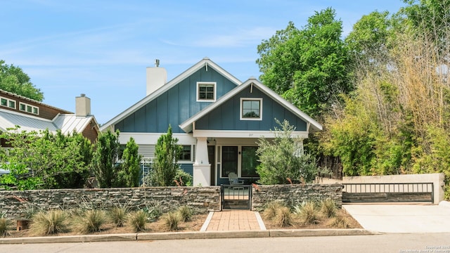 217 Alta, San Antonio, TX 78209 - craftsman inspired home featuring a gate, board and batten siding, a fenced front yard, and a chimney
