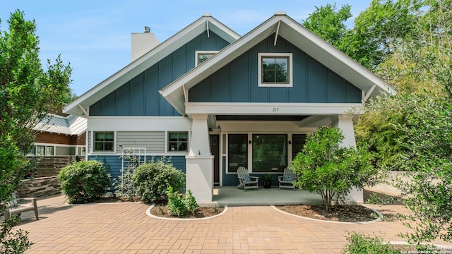 217 Alta, San Antonio, TX 78209 - rear view of house with board and batten siding, a porch, and a chimney