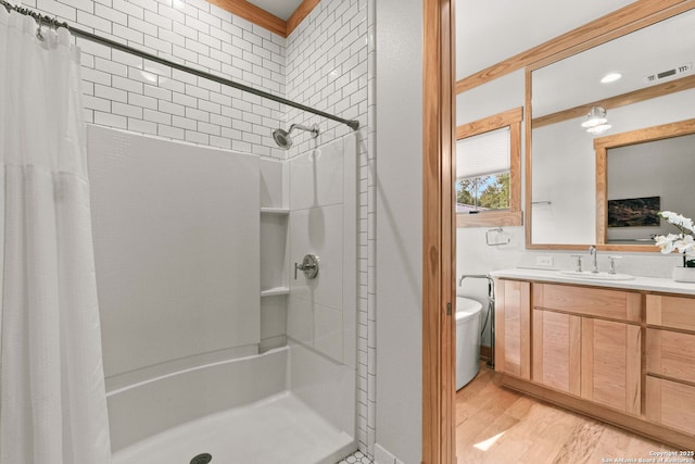 217 Alta, San Antonio, TX 78209 - full bathroom with a shower with shower curtain, vanity, and wood finished floors