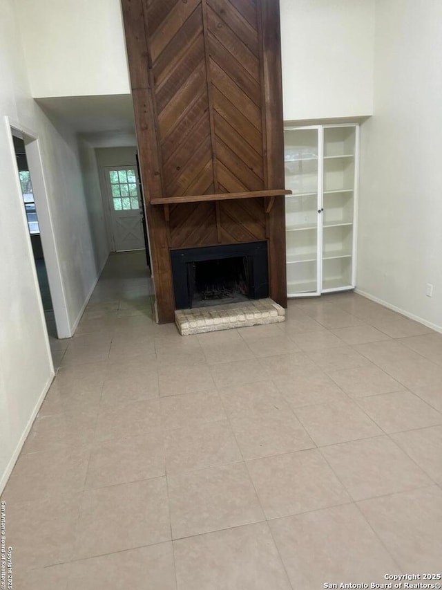 13136 Los Espanada, San Antonio, TX 78233 - unfurnished living room with a large fireplace and light tile patterned flooring