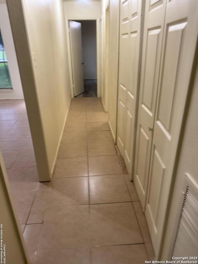 13136 Los Espanada, San Antonio, TX 78233 - corridor featuring light tile patterned floors and baseboards