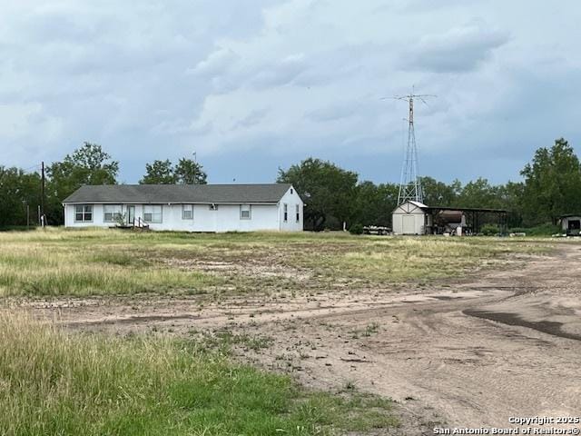 2065 Corgey, Pleasanton, TX 78064 - rear view of property featuring a detached carport and dirt driveway